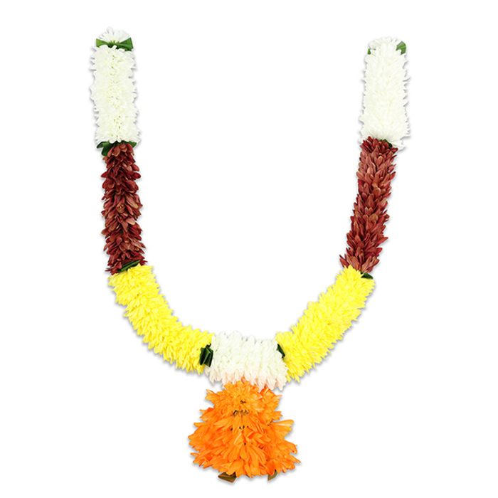 Shown against a stark white field, this U-shaped toran combines classic Indian colour symbolism with careful hand-finished construction - an artful piece you might see welcoming guests to a puja or wedding in Epping. The topmost sections begin with compact, creamy-white florets, densely threaded to create a soft, pillow-like crown that evokes chrysanthemum or small carnation textures and lends a tone of purity and calm. Directly beneath, rich reddish-brown segments appear as tightly packed, textured petals or flattened leaf-like forms, their depth and warmth grounding the garland. The arms curve down into a generous band of saturated golden yellow: fluffy, marigold-like clusters that form the broad U and radiate celebratory brightness. A dramatic central pendant of bright orange blossoms - layered, ruffled and voluminous - hangs from the lowest point, serving as a bold focal tassel whose colours shift from deep saffron to lighter orange at the edges. Fine green accents are woven at colour transitions, simulating leaf joins and giving the design visual relief. The materials read as quality artificials - resilient fibres, neat stitching and weight sufficient to drape well - making this toran practical for repeated festival use, temple decoration, or as a permanent doorway adornment for Epping households. As a local florist supplying items for markets near the town centre and community events by St John's Church and Epping Forest, I would pair this with simple string lights and an incense burner to create a welcoming ceremonial display that balances tradition, durability and seasonal cheer. (Available locally through Flowers Epping on flowersepping.pro.)