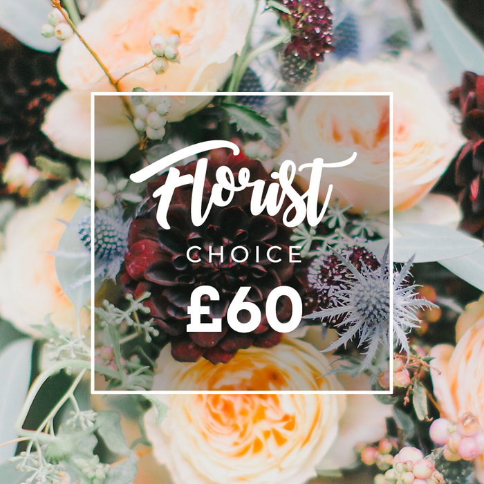 This detailed, painterly close-up captures an expertly composed bouquet that balances drama and tenderness. Dominating the scene, a sumptuous deep burgundy dahlia draws the eye with its dense, velvety petals, while surrounding garden roses in soft peach and creamy ivory unfurl in layered, romantic rosettes. Interspersed are cool, steel-blue eryngium thistles whose bristly forms introduce a bracing architectural element, and clusters of pale green-to-white berries that lend a lively, textured punctuation. Eucalyptus leaves and an assortment of green foliage-some smoky and rounded, others glossy and elongated-fill the negative space, giving the arrangement a natural, collected-from-the-hedgerow feel. The lighting is gentle yet revealing, skimming edges and casting soft shadows that emphasize the tactile differences between the plush rose centers and the thistle's spines; one can almost sense the subtle honeyed fragrance of the roses married to the crisp, slightly resinous scent of eucalyptus. Laid over the center is a white square frame with softly rounded corners containing elegant script that reads Florist, with CHOICE beneath in neat uppercase and the price ?60 in bold sans-serif, the white typography set to remain readable against the darker floral backdrop. This bouquet evokes the tone of a thoughtful gift or an intimate wedding posy, the kind of seasonal composition a florist from Epping might prepare for delivery to Bell Common, St John's Road, or a reception hosted near the edge of the forest.