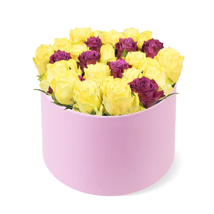 Luxuriously concentrated and sculpted, this floral display is presented in a round, light-pink gift box with a soft, velvety matte finish. The box anchors the lower portion of the image, its curved edges supporting a dense, domed cluster of thirty to forty roses. The dominant language is sunshine: bright yellow roses with tightly furled petals suggesting the moment of first bloom, filled with the scent of summer and the promise of warmth. Interwoven among the yellows are deep purple or burgundy roses, their darker tones weaving depth and elegance into the composition. The blooms are pressed together with craftsmanship that makes the arrangement appear full yet refined, a testament to the designer's eye for balance, proportion, and texture. The white background isolates the bouquet, ensuring the colours take center stage while the pale pink box acts as a gentle cradle rather than a distraction. The box's soft-touch surface and rounded silhouette convey premium quality, while the tight packing creates a tactile sense of abundance-perfect for celebratory occasions, anniversaries, or a bold gesture of friendship in Epping. This arrangement would work beautifully as a luxury delivery to a doorstep on Epping High Street, near the green, or as a centerpiece for a small gathering in a home close to Epping Forest. The overall effect is one of curated sophistication: vibrant, energetic, and confident, yet intimate enough to feel personal and thoughtful, a bouquet you can entrust to a local florist who understands how to tailor colour and form for the moment.