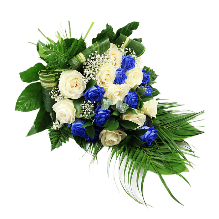 A luxurious cascading spray of roses in blue and white lies against a stark white background, its elongated teardrop profile flowing from a generous cluster of blooms at the upper left and tapering into a gentle point at the lower right. The arrangement is densely filled with fully opened ivory and off-white roses, their soft petals layered like silk, interwoven with equally abundant deep sapphire blue roses that add drama and depth. Each rose head appears full and rounded, giving the display a plush, generous look that feels appropriate for a formal farewell or memorial gathering in the Epping area. Throughout the composition, delicate stems of white baby's breath thread between the larger blooms, creating a cloud-like veil that softens the strong contrast of blue and white. Surrounding this central mass of roses is a carefully constructed frame of greenery. Bright green ferns with fine, feathery fronds emerge at the upper left, adding a sense of lift and freshness. Behind and beneath the flowers, broad, glossy dark-green leaves provide structure and a rich, shadowed backdrop. From the lower right corner, long arching palm fronds extend elegantly outward, defining the signature cascading silhouette associated with traditional funeral sprays and sympathy tributes. Small sprigs of silvery-green, eucalyptus-style foliage peek through the roses, contributing a cooler note and subtle variation in leaf shape. Wide green leaves have been folded and wrapped into neat horizontal bands, giving a tailored, contemporary edge to an otherwise classic design. The overall mood is solemn yet refined, a peaceful tribute that would sit beautifully beside a coffin or memorial photograph at services held in local chapels, churches, or crematoria around Epping.