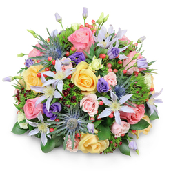 Presented against a clean white backdrop with a delicate shadow, this dense, round bouquet reads like a small, cultivated garden captured in a single hand-tied design. At its core, garden roses in soft blush pinks, warm buttery yellows, and gentle peaches open in layered curls that invite touch and linger visually as the bouquet's romantic centrepiece. Interspersed are pale lavender and white clematis flowers, their star-like petals and bright centres lending an airy, wildflower quality that softens the formal dome. The composition is smartly balanced by dramatic blue Eryngium (sea holly) thistles-spiky, steel-blue heads that give the arrangement an architectural silhouette and contemporary contrast. Deeper purple lisianthus, both budded and partially open, create pockets of shadowed colour while clusters of glossy red Hypericum berries add lively, jewel-like accents throughout. The supportive greenery ranges from broad, shiny foliage providing structure to delicate, feathery greens that add depth, with touches of near-burgundy filler foliage peeking through to enrich the palette. The scent is a quiet mix of rose sweetness and fresh green notes, the kind of aroma you might notice on a market morning on Epping High Street. Crafted with neighbourhood care by Flowers Epping, this bouquet suits a wide range of uses-an elegant table centre, a joyful celebration bouquet, or a gentle sympathy arrangement-available for local delivery across Epping and to nearby streets around the station.