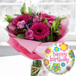 A vibrant birthday flower and balloon gift set is displayed in soft natural light, as if placed by a sunny window in an Epping home. At the heart of the scene is a lavish bouquet in a tall, clear glass cylinder vase, the stems neatly visible through the water. Large fuchsia and magenta gerbera daisies, with velvety petals circling dark, inky centers, stand proudly at the front, creating an immediate sense of joy. Around them are clusters of blush and mid-pink roses, some held tightly in bud, others beginning to unfurl their layered petals, suggesting a gentle, romantic fragrance. Wisps of deep purple filler flowers thread between the main blooms, while an abundance of fresh, glossy green foliage fans out to give the design fullness and movement. The base of the arrangement is wrapped in crinkled, translucent pink cellophane that rises like a soft halo around the flowers, catching the light. Tied with rustic twine around the vase is a small, off-white swing tag bearing a subtle rose motif, hinting at a premium florist touch familiar to those who send birthday flowers across Epping and nearby Theydon Bois. In the foreground to the right, a round Mylar birthday balloon floats cheerfully, its white background softly speckled with grey. The words happy birthday sweep across the centre in playful pink script, ringed by stylised flowers and circular patterns in sunny yellow, sky blue, lime green, bright pink and rich purple. The shallow depth of field blurs the indoor background, so all attention rests on this thoughtful, ready-to-deliver birthday surprise that feels perfect for marking a special year or a cosy family celebration off Epping High Street.