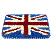 In this image, a large rectangular floral arrangement has been lovingly designed to mirror the Union Jack, its colours and lines rendered entirely in fresh, tightly packed flowers. The background is a rich expanse of deep blue blossoms, their petals forming a smooth, cushiony surface that hints at careful, methodical placement by an experienced florist. Across this backdrop, the bold white arms of the St George's Cross stretch from edge to edge, created from crisp, small-headed blooms that sit closely together, giving the impression of a solid white band. Diagonal red stripes, representing the St Patrick's Cross, cut confidently through the design, made from vivid red carnations or similar flowers whose velvety texture brings warmth and emotional weight. Each red diagonal is framed by a fine border of white petals, preserving the clarity of the flag's pattern and adding a sense of craftsmanship. The arrangement has a gentle dome to it, so the floral flag seems to lift slightly from the surface, catching light and shadow across the different textures. At the base, a neatly pleated royal-blue satin ribbon runs the full width of the tribute, echoing the blue floral field above and giving a formal, almost regimental finish. This Union Jack design would be especially fitting for military funerals, remembrance services, or patriotic farewells held in Epping and nearby areas such as Loughton or Buckhurst Hill, where families may wish to acknowledge service, loyalty, or a lifelong connection to Britain. The overall mood is one of quiet honour and enduring respect, conveyed through colour, form, and the living beauty of fresh flowers.