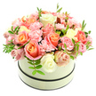 A plush, domed floral composition of roses and ruffled carnations sits arranged in an elegant round hatbox, its pale cream surface softened by a matte finish and set off by two narrow, dark bands-one circling the top rim and another near the base-creating a refined, timeless silhouette against a clean white background. The bouquet spills generously from the box in a tightly packed, almost pillow-like mound: large velvet roses open in stages, their centers a warm coral-peach and apricot glow that blushes outward to soft pink and then to creamy ivory at the petal edges. Between these larger blooms nestle clusters of delicate, light baby-pink carnations whose frilled petals add a feathery texture and intimate detail. Scattered sparingly through the mass are slim sprigs of fresh green foliage with small elongated leaves, providing cool contrast and breathing space among the blooms. Soft, natural light falls from above, catching the subtle sheen on petals and casting gentle shadows that emphasize depth and craftsmanship, while a faint, powdery floral scent is suggested by the image's composition. This arrangement reads as both luxurious and approachable-perfect for birthdays, anniversaries, a heartfelt thank-you, or to brighten a bedside table on a quiet morning. As a local piece inspired by Epping's leafy character-think the calm of Epping Forest at dawn-the design blends classic romance with contemporary restraint, a bouquet that invites touch, pause, and the small comfort of fresh flowers delivered with care to the High Street, Bell Common or nearby homes in the Epping area.