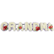 A heartfelt funeral tribute carefully shaped into the word 'GRANDMA', each letter formed from densely packed, creamy-white cushion chrysanthemums (or similar spray blooms) that create a plush, cloud-like surface. Soft pale-lilac ribbon weaves a gentle halo around each character, the cool lilac edging catching the soft studio light and lending a calm, reverent mood. Scattered across the letters are vivid clusters of deep red blooms - glossy roses and rich carnations - placed at the opening, centre and close of the name to read like small, bright signatures of love against the white background. Distinctive red anthurium lilies, their heart-shaped, waxy surfaces catching highlights, anchor the first 'A', the central 'M' and the final 'A', while the sweeping curve of the 'G' is punctuated by a dramatic variegated red-and-white calla lily tucked into its interior, offering a single, elegant focal point.
The letters sit on a subtle dark-green support frame that keeps the composition upright and cohesive, the metal hidden beneath a fringe of foliage so the focus remains on the flowers and message. As a local florist who has prepared many memorial pieces for families around Epping and beside Epping Forest, I imagine the cool, quiet scent of chrysanthemums mingling with the faint perfume of roses - a gentle, familiar comfort at a service on High Street or a graveside near St John's Road. This arrangement reads as dignified, personal and comforting: a clear, tender farewell to a beloved grandmother, designed to be both readable from a distance and soft to the touch close-up.