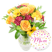 A joyful, gift-ready bouquet captured against a clean white backdrop, composed to feel like a warm hug from a local florist in Epping. The arrangement centers on full, peachy-orange and bright yellow roses whose gently unfurling petals catch a soft, diffused light; they smell faintly of warm honey and fresh garden mornings. Scattered among them are sunny yellow gerbera daisies with dark, almost black centers that read like little suns, while deep burgundy carnations add a velvety, ruffled counterpoint and a sense of depth. Slim white alstroemeria (Peruvian lilies) with delicate speckling thread through the composition, offering a lighter, almost lace-like texture that lifts the palette. A generous cloud of glossy green foliage-broad leaves and slender sprigs-frames the blooms and gives the bouquet a lush, collected-from-the-garden feel. The stems are neatly gathered in a clear glass vase; the water line and intersecting stems are visible, reinforcing the freshness and careful craftsmanship of the arrangement.
To the lower right, slightly overlapping the vase, a round white Mylar balloon adds a playful, celebratory note. It's dotted with scattered gold and vivid pink polka dots and tiny hearts, and bears the handwritten-style message best Mum in lively hot-pink script, making the set unmistakably intended for a mother's special day. The overall mood is bright, affectionate, and artisanal-the kind of floral gift you might choose after a stroll through Epping High Street or a quiet visit to Epping Forest, intended to make a mother smile and to fill a kitchen table with colour and warmth.
