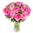 A lush dome of nearly two dozen freshly cut pink roses rests in a clear glass vase, photographed against a crisp white backdrop so every nuance of colour and texture reads clearly. Each bloom opens in a tight spiral, the innermost petals showing a deep fuchsia or magenta that gently mellows outward into soft blush pink and, on some outer petals, a creamy ivory sheen. The roses are packed closely to form a full, rounded silhouette, while rich, glossy green leaves peek between heads and cradle the bouquet, adding depth and a natural contrast to the pinks. Through the transparent, slightly curved vase you can see neatly trimmed green stems standing in clear water, the cool, glassy surface catching soft highlights from bright, even lighting that emphasizes the satiny petal folds. Imagine the faint, sweet perfume typical of garden roses-fruity and green-lifting from the cluster, an olfactory whisper of early summer mornings beside Epping Forest. The composition feels both celebratory and intimate, equally at home as an anniversary gift on a High Street café table or as a thoughtful Mother's Day surprise delivered to a home near Epping Underground. As a local florist I'd describe this arrangement as classic yet modern: confident in colour, meticulous in construction, and designed to convey affection and warmth. The photograph's pristine white setting keeps focus on floral form and freshness, making this bouquet an ideal visual for articles about thoughtful gift-giving, seasonal floristry, or styling fresh blooms in home interiors around Epping and nearby villages.